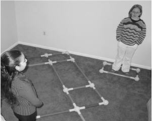 Above, a student (at right) in the Spelling Square attempts to spell a word so her teammate (left) can move into the obstacle course.